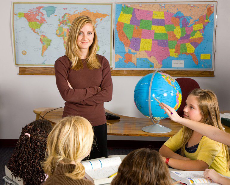 A teacher teaching some students in the class