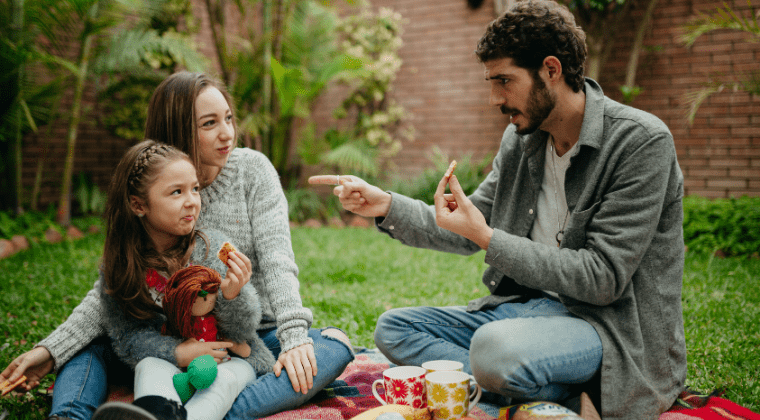 A family enjoying a picnic in the backyard, removing distractions and focusing attention with kids.