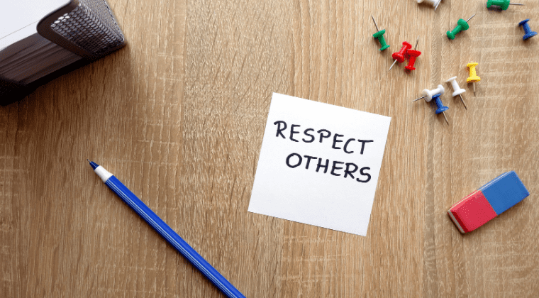 Respect others logo on a table along with a pen