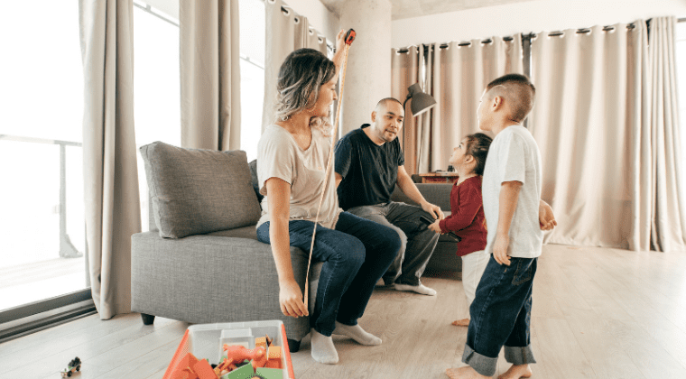 A family talking with some small children inside a house